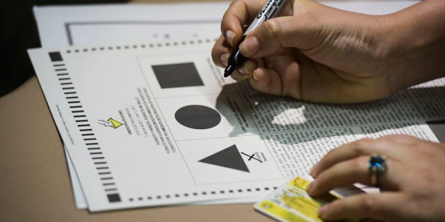 A Puerto Rican citizen votes during the fifth referendum in San Juan, Puerto Rico, Sunday, June 11, 2017. Residents of the U.S. Territory had to choose between the options of statehood, free association/independence and current territorial status. (AP Photo/Carlos Giusti)