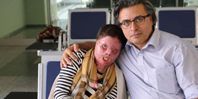 Yasmin, who set herself on fire to avoid a brutal attack by ISIS, is shown with Dr. Jan Kizihan.