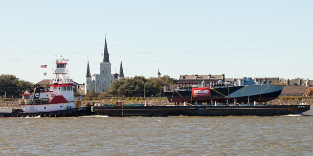 PT-305, atop a barge, heads toward Louisiana's Lake Pontchartrain.