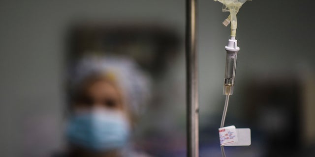 In this Oct. 7, 2016 photo, a nurse provides assistance to the surgical staff at the Dr. Isaac Gonzalez MartÃnez Oncological Hospital in San Juan, Puerto Rico, where services are offered to cancer patients with limited financial resources. Like many doctors, nurses are also moving to the United States in search of better wages. (AP Photo/Carlos Giusti)