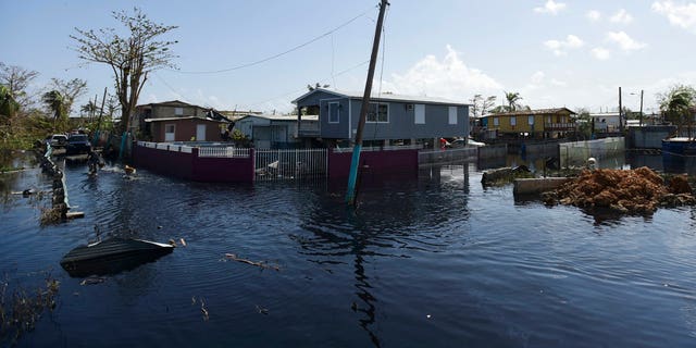 Homes are surrounded by floodwaters in Catano, Puerto Rico, on Sept. 28, 2017, one week after the passage of Hurricane Maria. 