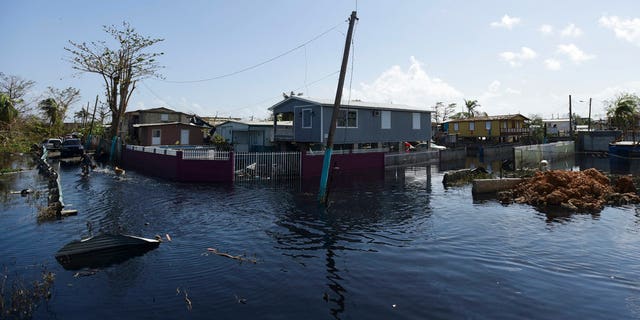 Homes are surrounded by floodwaters in Catano, Puerto Rico, on Sept. 28, 2017, one week after the passage of Hurricane Maria. 