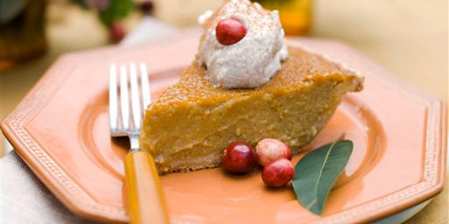 In this image taken on Oct. 8, 2012, a slice of maple pumpkin pie with cinnamon-maple whipped cream is shown served on a plate in Concord, N.H. (AP Photo/Matthew Mead)