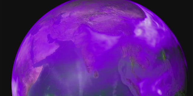 New research shows how winds push thick clouds of black carbon (shown in purple and white) and dust toward the base of the Himalayas where they accumulate, rise and drive a heat pump that affects the region's climate.