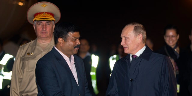 Dec. 10, 2014: Russian President Vladimir Putin, right, is received by Indian Minister of State for Petroleum, Dharmendra Pradhan