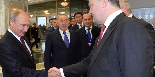 Aug. 26, 2014: Russian President Vladimir Putin, left, shakes hands with Ukrainian President Petro Poroshenko, right, as Kazakh President Nursultan Nazarbayev, center, looks at them, prior to their talks after after posing for a photo in Minsk, Belarus. Leaders of Russia, Belarus, two other former Soviet republics as well as top EU officials are meeting in Minsk, Belarus, for a highly anticipated summit to discuss the crisis in Ukraine which has left more than 2,000 dead and displaced over 300,000 people.