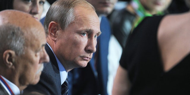 Sept. 7, 2015: Russian President Vladimir Putin, center, listens to a question during a meeting with his supporters in Moscow, Russia.