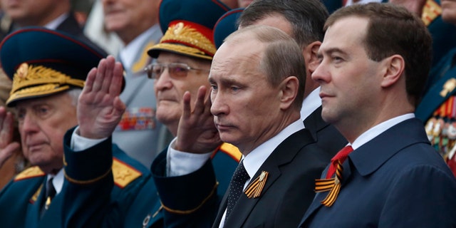 May 9, 2012: Russian President Vladimir Putin, second right, and Prime Minister Dmitry Medvedev, right, watch the Victory Day Parade, which commemorates the 1945 defeat of Nazi Germany on the Red Square in Moscow,  Russia.