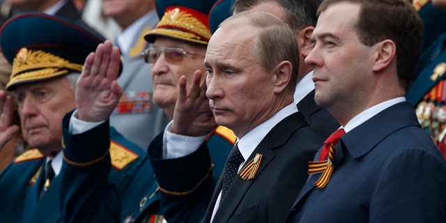 May 9, 2012: Russian President Vladimir Putin, second right, and Prime Minister Dmitry Medvedev, right, watch the Victory Day Parade, which commemorates the 1945 defeat of Nazi Germany on the Red Square in Moscow, Russia.