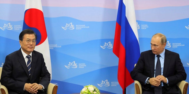 South Korean President Moon Jae-in, left, and Russian President Vladimir Putin meet at the Eastern Economic Forum in Vladivostok, Russia, Sept. 6, 2017.