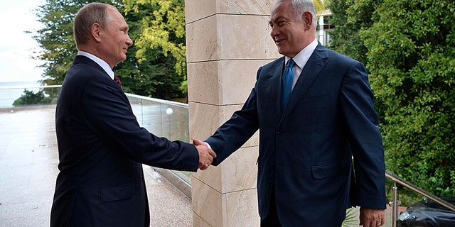 Russian President Vladimir Putin, left, welcomes Israeli Prime Minister Benjamin Netanyahu.