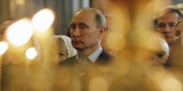 Vladimir Putin attends a Russian Orthodox Christmas service in 2012. (AP)