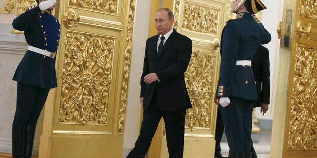 Russia's President Vladimir Putin walks past honor guards as he attends a ceremony to receive diplomatic credentials from foreign ambassadors at the Kremlin in Moscow, Russia, November 26, 2015. (REUTERS/Sergei Ilnitsky/Pool)