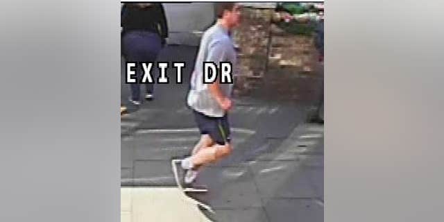 CCTV image of the man London police say pushed an unidentified woman in front of an incoming bus that narrowly missed her.