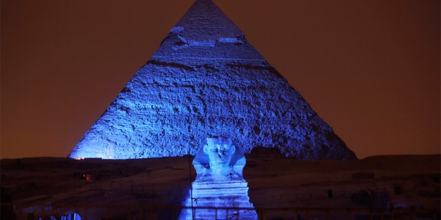 The Sphinx and the historical site of the Giza Pyramids are illuminated with blue light, as part of the celebration of the 70th anniversary of the United Nations in Giza, just outside Cairo, Egypt, in 2015.