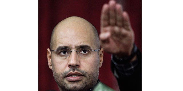 March 10, 2011: Seif al-Islam Qaddafi, son of Libyan leader Muammar Qaddafi, gestures as he speaks to supporters and the media in Tripoli, Libya.
