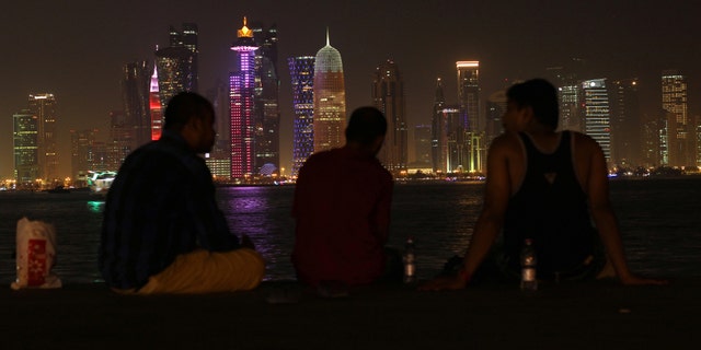 People sit on the corniche in Doha, Qatar, June 15, 2017.