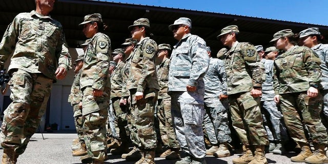 Arizona National Guard soldiers line up as they get ready for a visit from Arizona Gov. Doug Ducey prior their deployment to the Mexico border at the Papago Park Military Reservation Monday, April 9, 2018, in Phoenix.