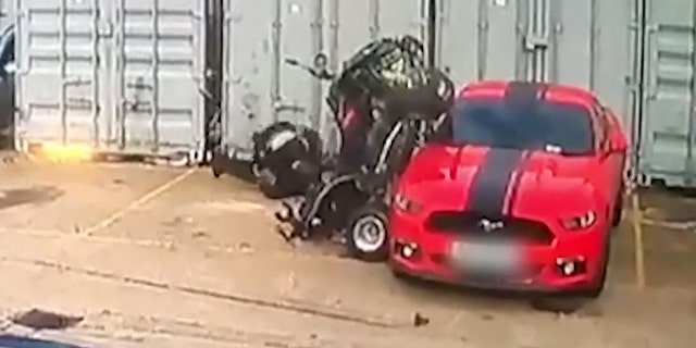 He was thrown to the ground as the bike rammed the car, hurting his leg and wrist.