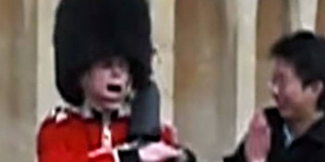 The moment a Queen's Guard pulls rifle on a tourist who touched him.