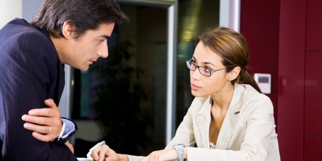 Office life: young salesclerk talking to a customer