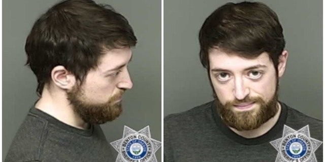 Andrew Joseph Oswalt was charged with four criminal counts Tuesday, including hate crimes for pasting racist bumper stickers on cars at a Corvallis co-op.