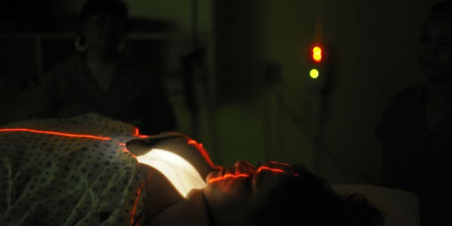 A breast cancer patient undergoes radiation treatment (REUTERS/Jorge Cabrera)