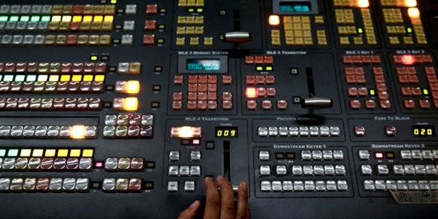 An employee operates a mixing console at the control room of state broadcaster ERT headquarters in Athens June 17, 2013. Greek Prime Minister Antonis Samaras faced a double challenge on Monday from coalition partners furious over the shutdown of state broadcaster ERT and a court hearing that could put the shuttered station back on air. REUTERS/Yorgos Karahalis (GREECE - Tags: BUSINESS POLITICS MEDIA EMPLOYMENT) - RTX10QP0