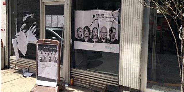 A ripped up poster advertising the streaming event of Radiohead's new album, at a record shop, in Istanbul, Saturday, June 18, 2016. (AP Photo/Dominique Soguel)