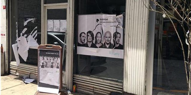 A ripped up poster advertising the streaming event of Radiohead's new album, at a record shop, in Istanbul, Saturday, June 18, 2016. (AP Photo/Dominique Soguel)