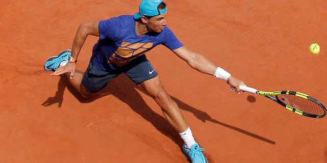 Spain's Rafael Nadal returns the ball during a training session of the French Open tennis tournament at the Roland Garros stadium, in Paris, Saturday, May 21, 2016 . The French Open starts Sunday May 22. (AP Photo/Christophe Ena)