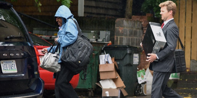 Federal Agents exit the back of an office building as the FBI serves a search warrant at the office of Strategic Campaign Group on Thursday, May 11, 2017 in Annapolis, Md.
