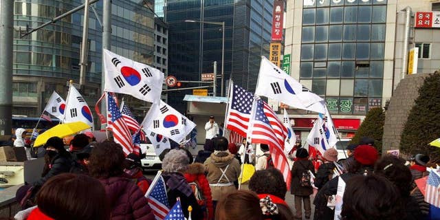 South Korean and American flags are waved at rallies against the current South Korean government, led by Moon Jae-in.