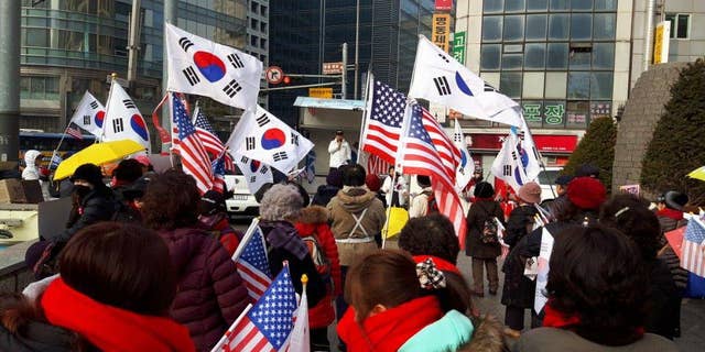 South Korean and American flags are waved at rallies against the current South Korean government, led by Moon Jae-in.