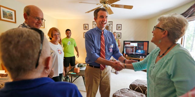 Democratic candidate for governor, Lt. Gov. Ralph Northam greets voters at a canvas kickoff Tuesday, June 13, 2017, in Chesterfield, Va. Lt. Gov Ralph Northam faces former Congressman Tom Perriello in today's primary. (AP Photo/Steve Helber)