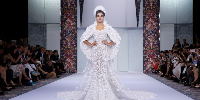 A model presents a wedding gown from Ralph & Russo at a fashion show in 2016. British media outlets speculate that the design house was chosen to make Markle's dress, as well.