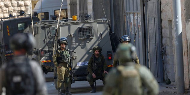 Israeli security forces raid the West Bank village of Deir Abu Mash'al near Ramallah, Saturday