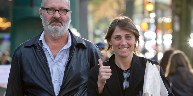 FILE - This Oct. 27, 2010 file photo shows, actor Randy Quaid, left, and his wife Evgenia outside their lawyer's office in Vancouver. Quaid and his wife sued John Kerry and the State Department on Monday, Dec. 15, 2014, to recover passports that the government revoked three years ago. The actor said the revocation involved an issue over "an insurance policy that we did not take out," but declined to discuss it further.