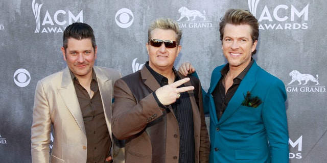 (L-R) Jay DeMarcus, Gary LeVox and Joe Don Rooney of the group Rascal Flatts arrive at the 49th Annual Academy of Country Music Awards in Las Vegas, Nevada April 6, 2014.  REUTERS/Steve Marcus  (UNITED STATES - Tags: ENTERTAINMENT)(ACMAWARDS-ARRIVALS) - RTR3K6SR