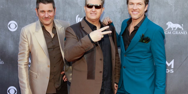 (L-R) Jay DeMarcus, Gary LeVox and Joe Don Rooney of the group Rascal Flatts arrive at the 49th Annual Academy of Country Music Awards in Las Vegas, Nevada April 6, 2014. REUTERS/Steve Marcus (UNITED STATES - Tags: ENTERTAINMENT)(ACMAWARDS-ARRIVALS) - RTR3K6SR