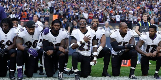 Baltimore Ravens players knelt during the playing of the U.S. national anthem on Sunday.