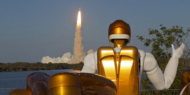 Robonaut R2A waving goodbye as Robonaut R2B launches into space aboard STS-133. R2 is the first humanoid robot in space.