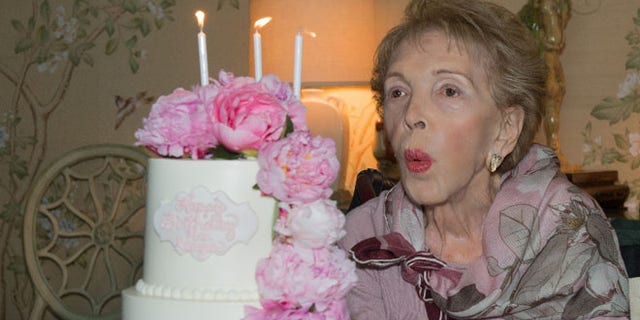 Nancy Reagan blows out her birthday candles on her 94th birthday on July 6, 2015.<br>