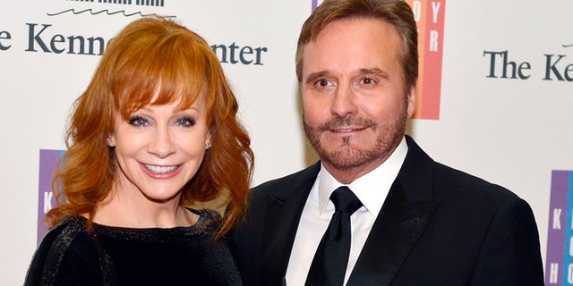 December 6, 2014. Country singer Reba McEntire and her husband Narvel Blackstock pose on the red carpet as they arrive ahead of the 37th Annual Kennedy Center gala dinner at the U.S. State Department, in Washington.