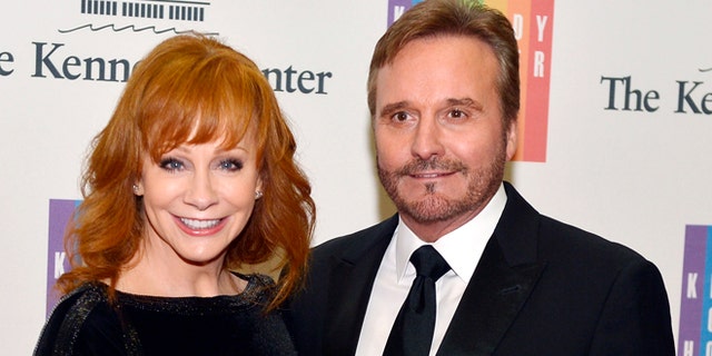 December 6, 2014. Country singer Reba McEntire and her husband Narvel Blackstock pose on the red carpet as they arrive ahead of the 37th Annual Kennedy Center gala dinner.