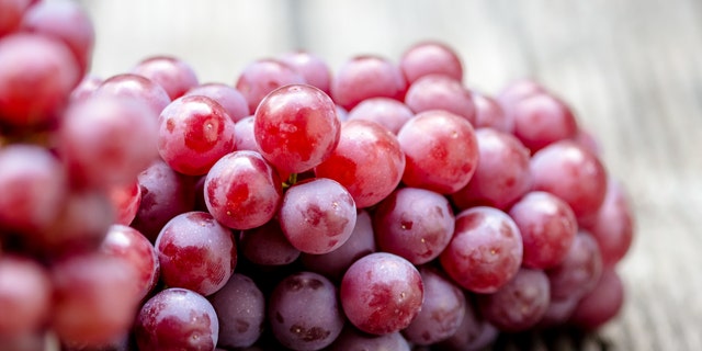 Red grape fruits on wooden