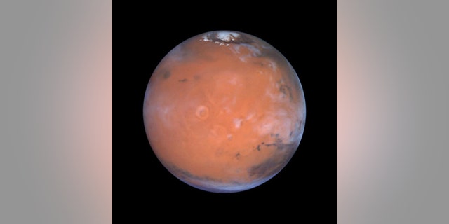 New research into old data suggests that ice may hide around Mars' equator. Here, the Red Planet is seen in a vivid Hubble view.