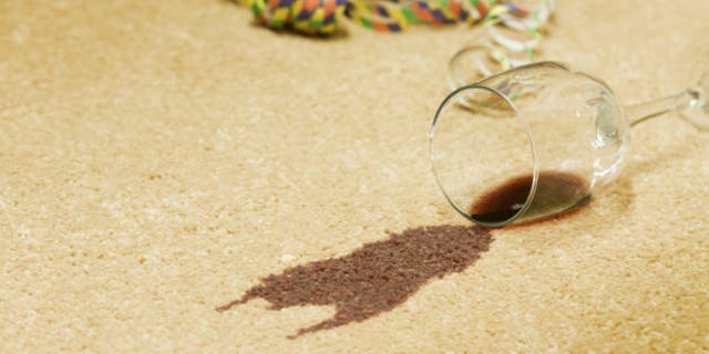 Red wine spilled on a beige carpet.
