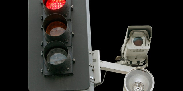 A red light camera setup is shown Wednesday Sept. 29, 2010 in Los Angeles. An audit by the Los Angeles city controller finds that red-light cameras haven't shown to improve public safety. The audit released Wednesday blames police for not adequately compiling statistics at the 32 intersections where red light cameras are installed, making it difficult to conclude whether they are effective. (AP Photo/Nick Ut)