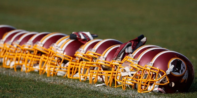 Aug. 4, 2009: Washington Redskins helmets are displayed on the field during NFL football training camp at Redskins Park in Ashburn, Va. (AP/Pablo Martinez Monsivais, File)